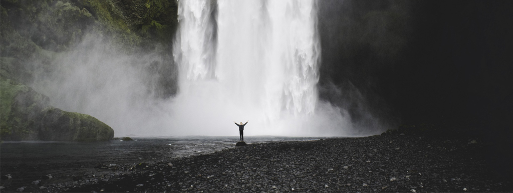 picture of a person standing in front of a waterfall illustrating the white paper about circular economy