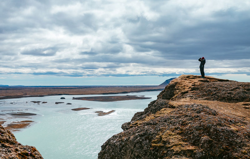 man standing at a shore illustrating climate strategy