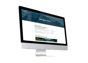A desktop computer displaying a website with the heading SBTi Quick-Check against a mountain background, on a white backdrop.