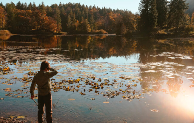 A kid in front of a lake
